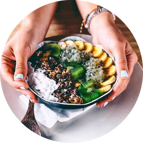 a person holding a bowl of fruit