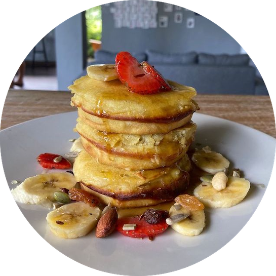 a stack of pancakes with fruit on top